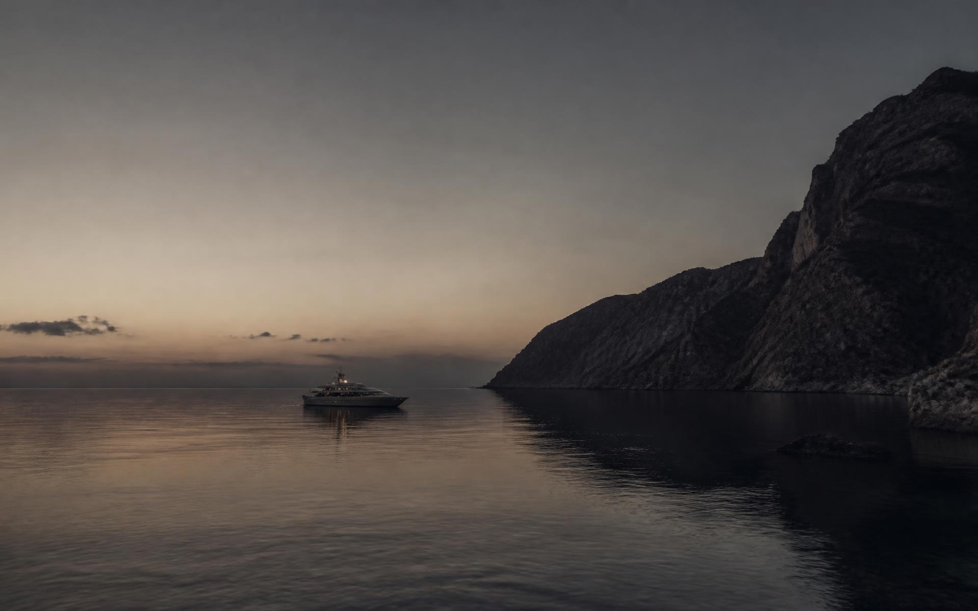 A superyacht anchored alone in a quiet Mediterranean bay at blue hour